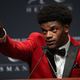 Lamar Jackson of the Louisville Cardinals points to his mother as he answers a question after being named the 82nd Heisman Memorial Trophy Award winner on Dec. 10, 2016, in New York City.
Michael Reaves/Getty Images